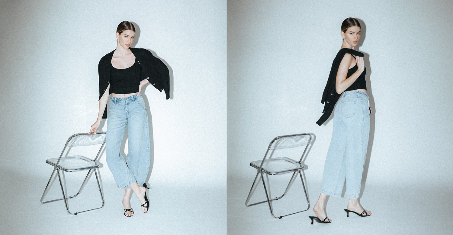 Model wearing Vervet Denim’s High Rise Front Seam Extreme Wide Barrel Leg Jeans with a black top and heels.