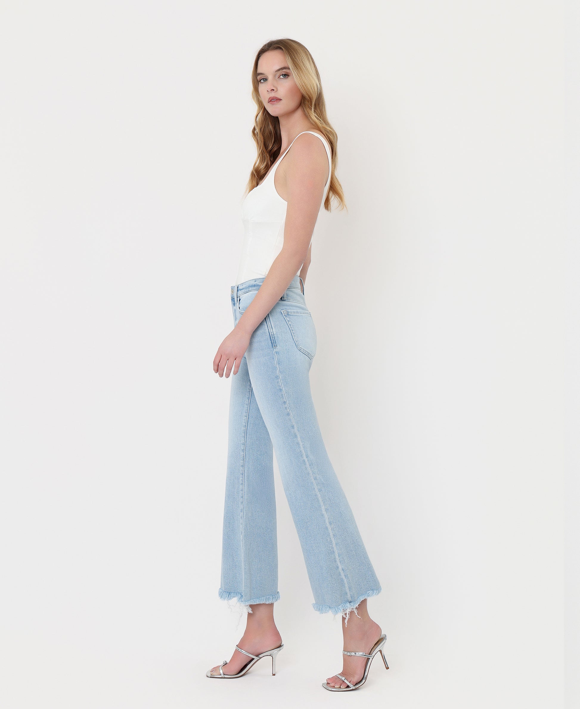 Left side product images of Charm - High Rise Uneven Frayed Hem Crop Easy Flare Jeans