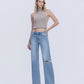 Front product images of Illustrative - Mid Rise Distressed Full Length Wide Leg Jeans