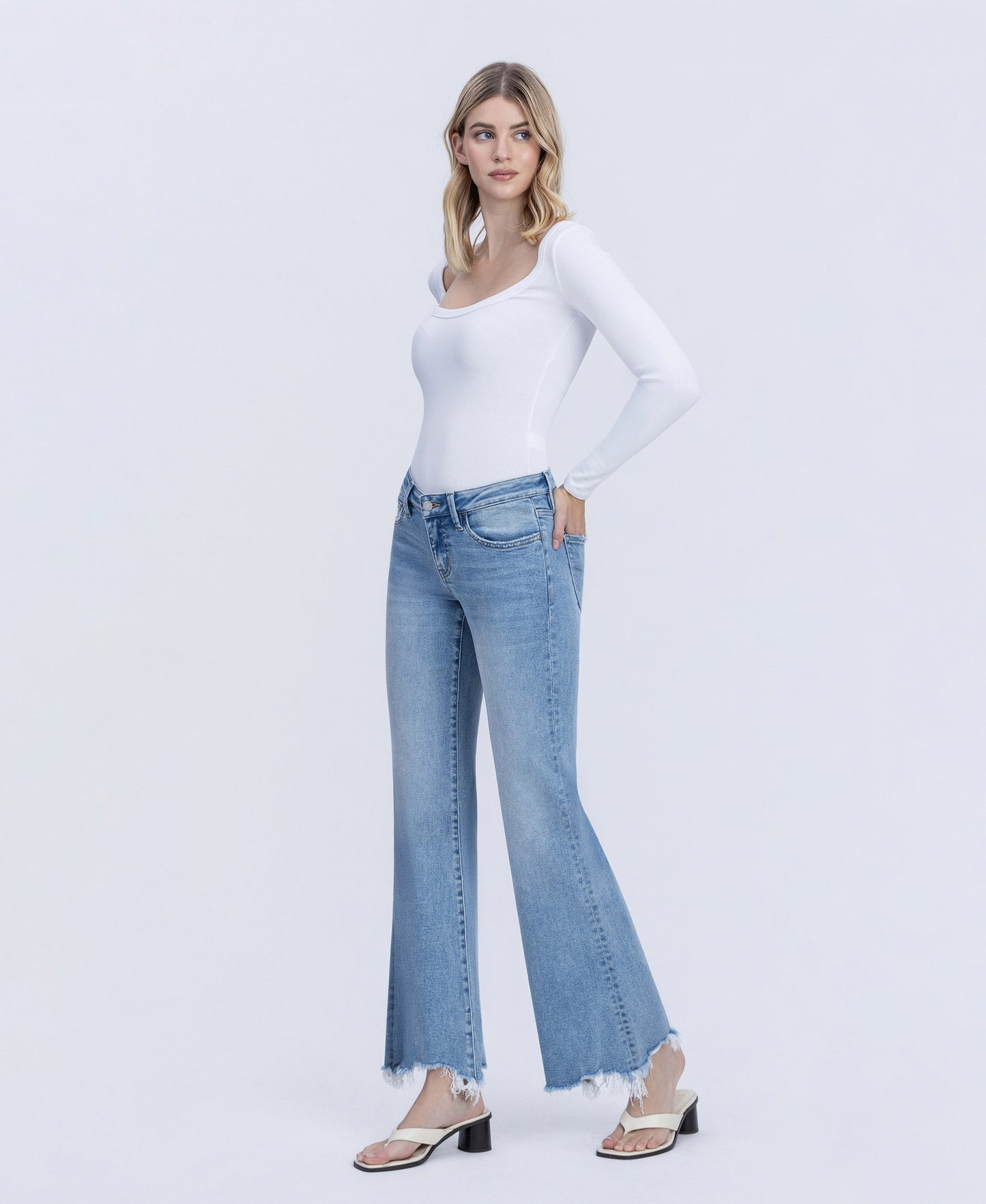 Left 45 degrees product image of Mirage - Low Rise Distressed Hem Easy Flare Jeans