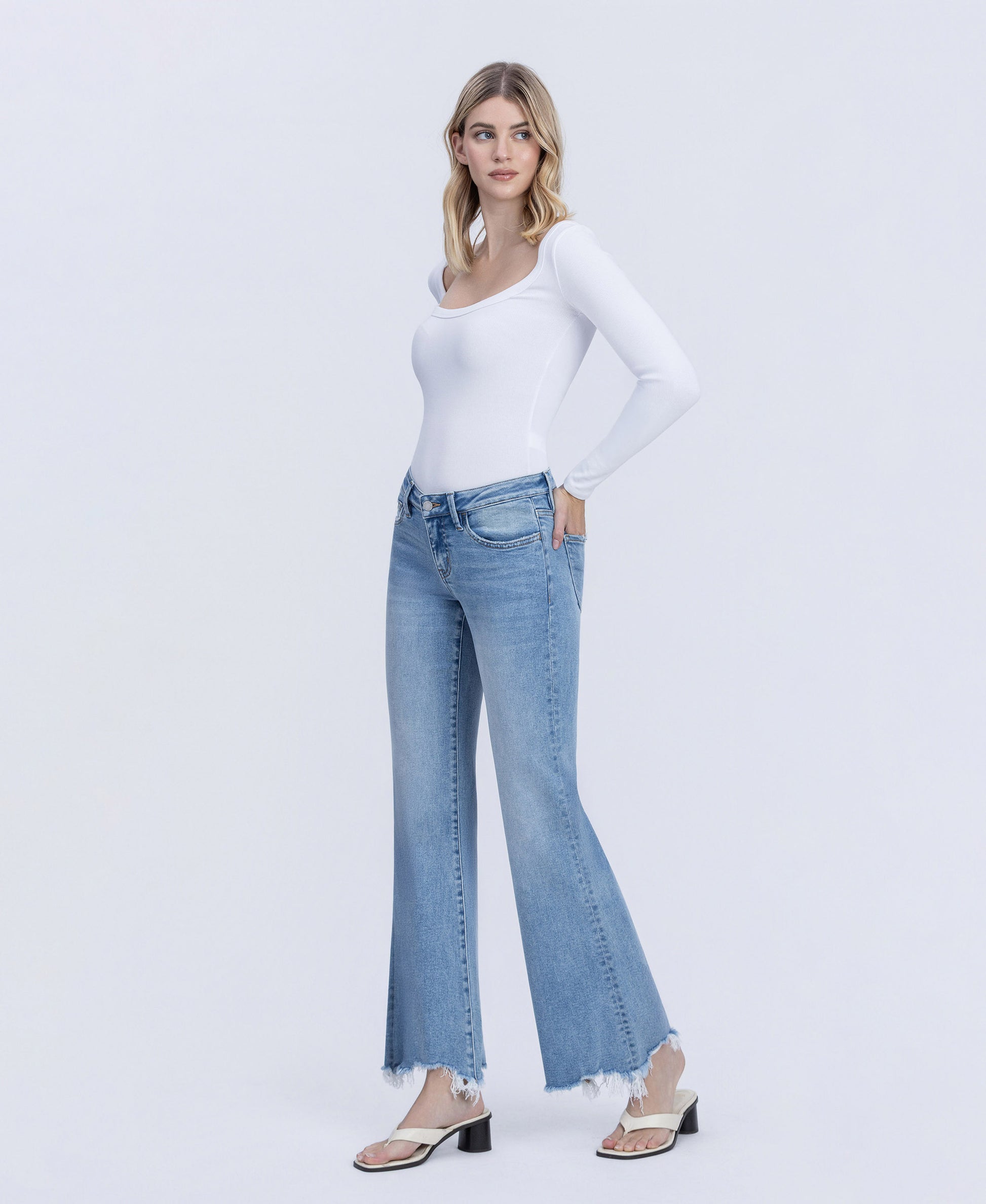 Left 45 degrees product image of Mirage - Low Rise Distressed Hem Easy Flare Jeans