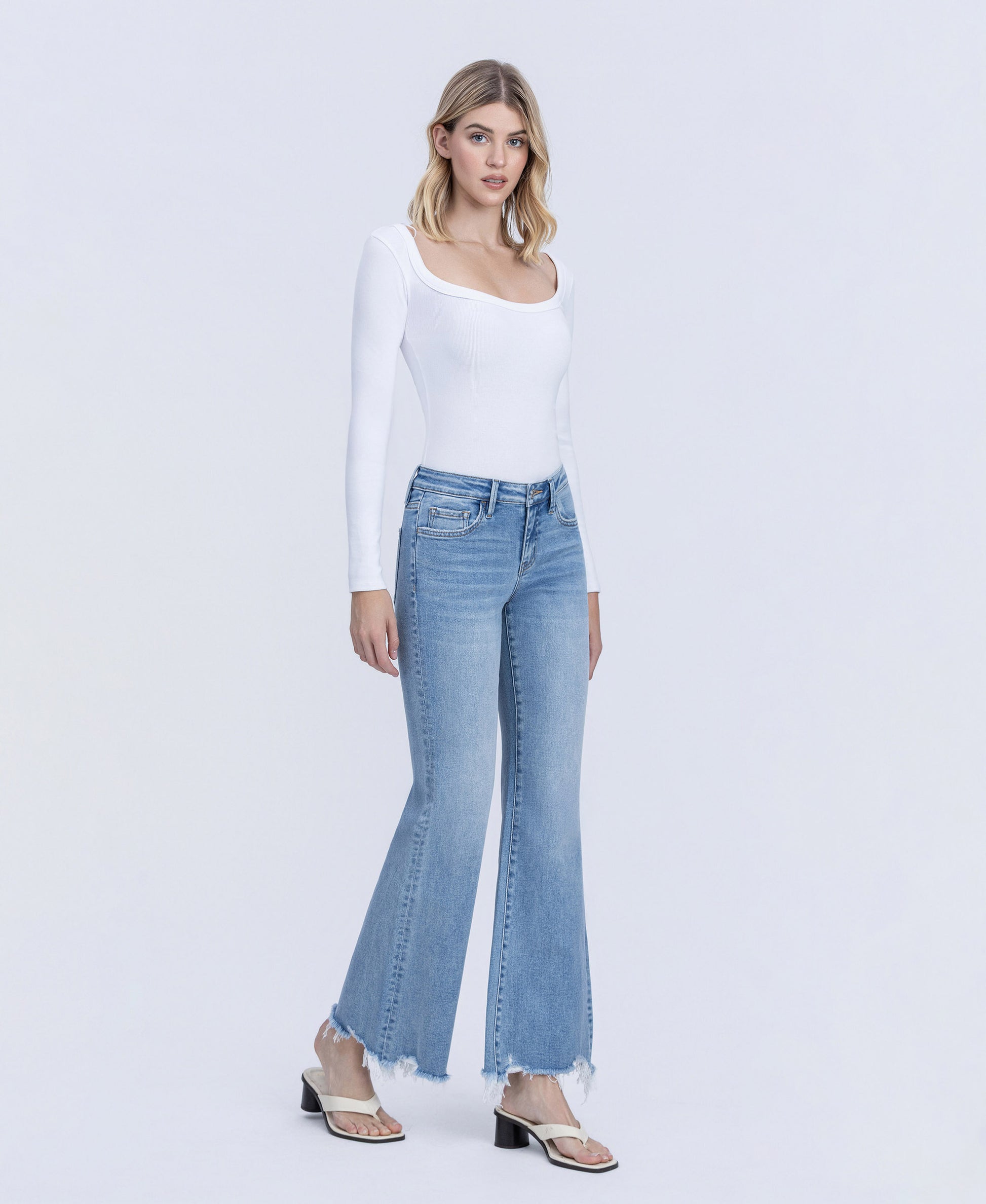 Right 45 degrees product image of Mirage - Low Rise Distressed Hem Easy Flare Jeans