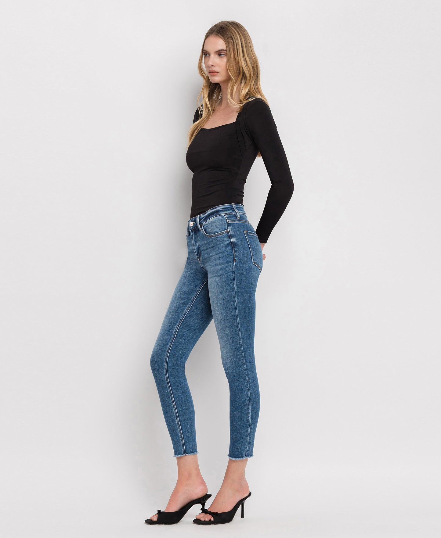 Left 45 degrees product image of Wolf N Crane - Mid Rise Raw Hem Cropped Skinny Jeans