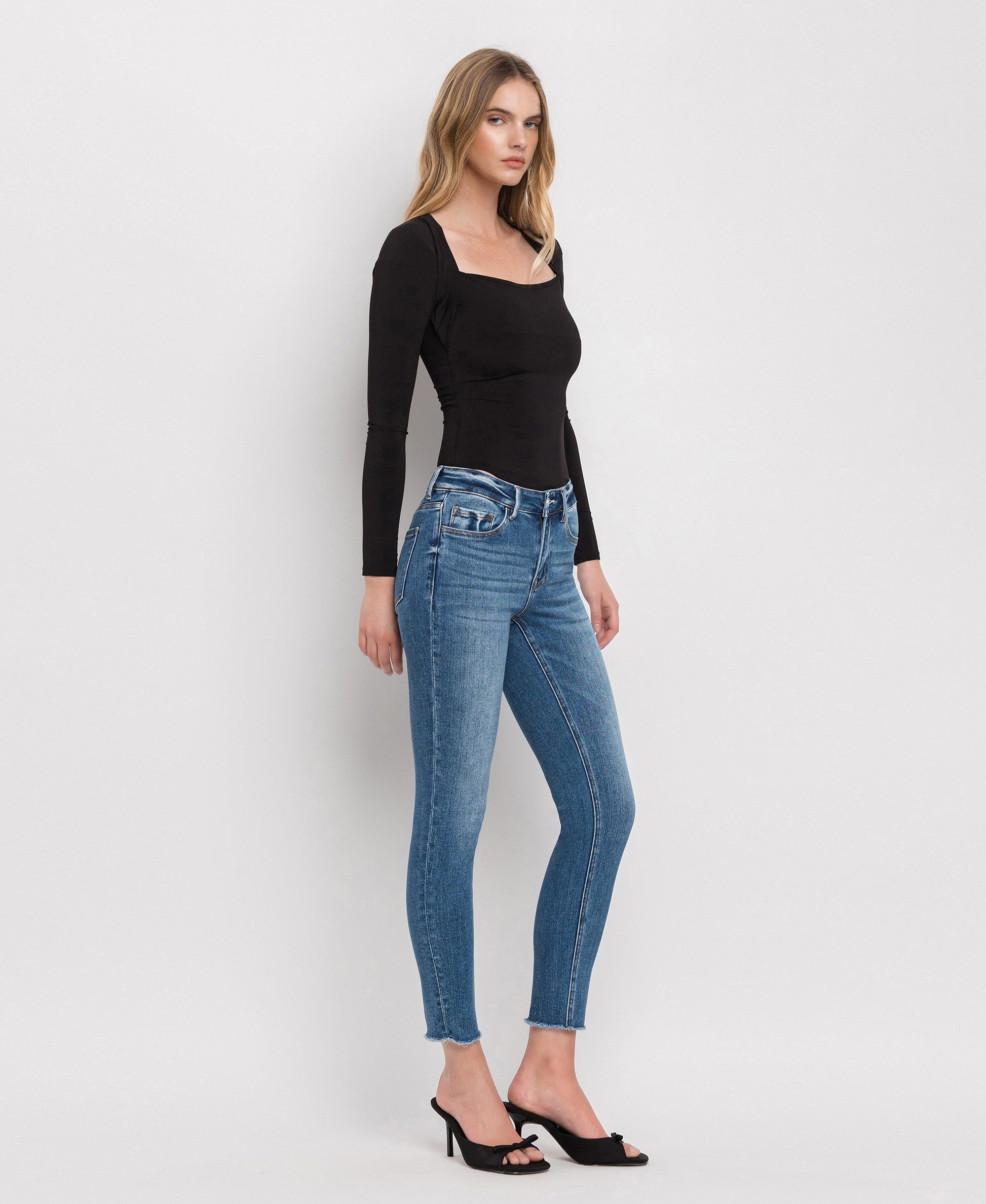 Right 45 degrees product image of Wolf N Crane - Mid Rise Raw Hem Cropped Skinny Jeans